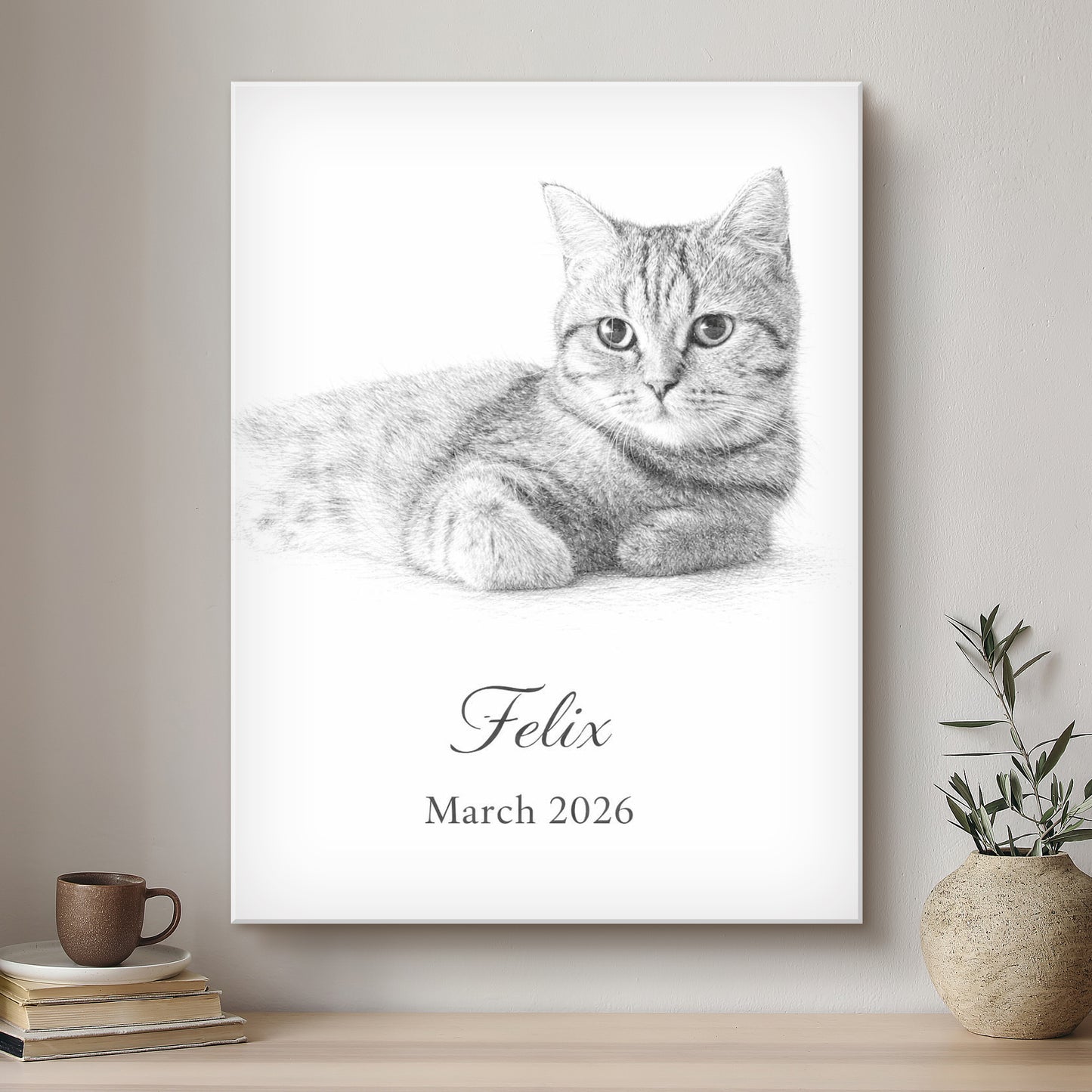 Framed artwork of a cat named Felix with the date March 2026, displayed on a wall.