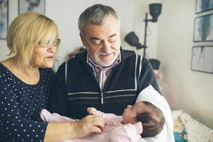 Grandparents holding baby and blurred background