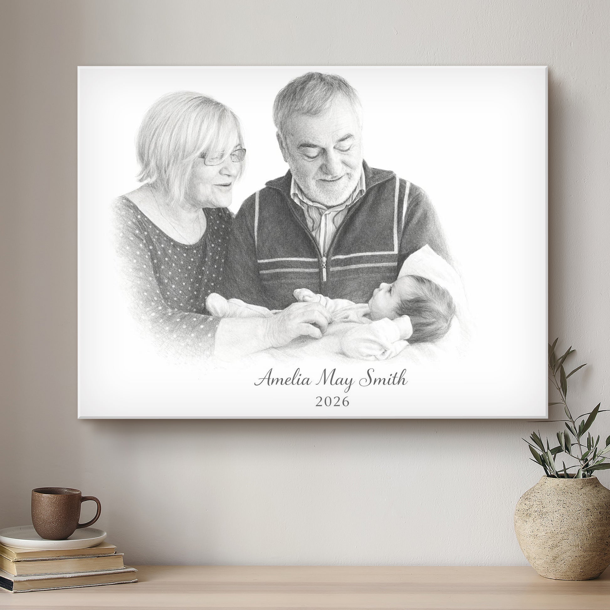 Canvas print of a family with a baby on a wall above a shelf with books and a plant.